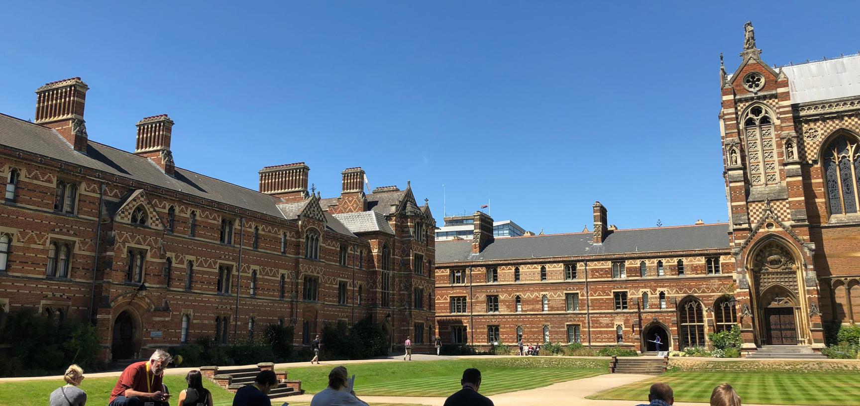 Students of the Digital Humanities @ Oxford Summer School enjoy a break in the sunlit courtyard of Keble College, Oxford