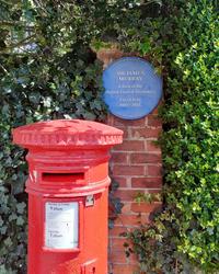 Image of a red pillarbox in front of a blue plaque for Sir James Murray