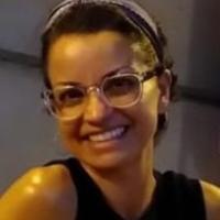 Adi Keinan-Schoonbaert smiling and wearing glasses