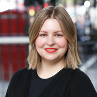 A smiling portrait of Dr Antonina Puchkovskaia in front of a blurred background